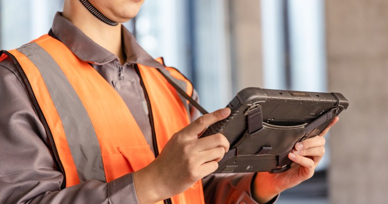 Construction worker using a heavy duty rugged tablet for daily field work