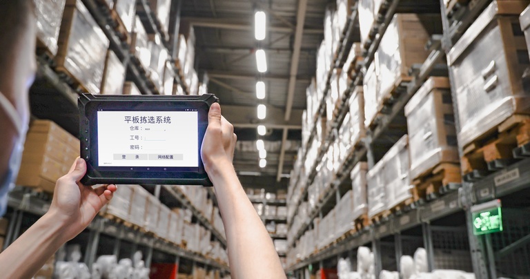 Rugged tablet running a warehouse management system (WMS) for inventory tracking and warehouse operations.